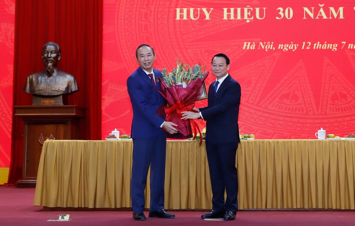 Bộ trưởng Đỗ Đức Duy tặng hoa chúc mừng Thứ trưởng Phùng Đức Tiến. Ảnh: Khương Trung. Bộ trưởng Đỗ Đức Duy tặng hoa chúc mừng Thứ trưởng Phùng Đức Tiến. Ảnh: Khương Trung.