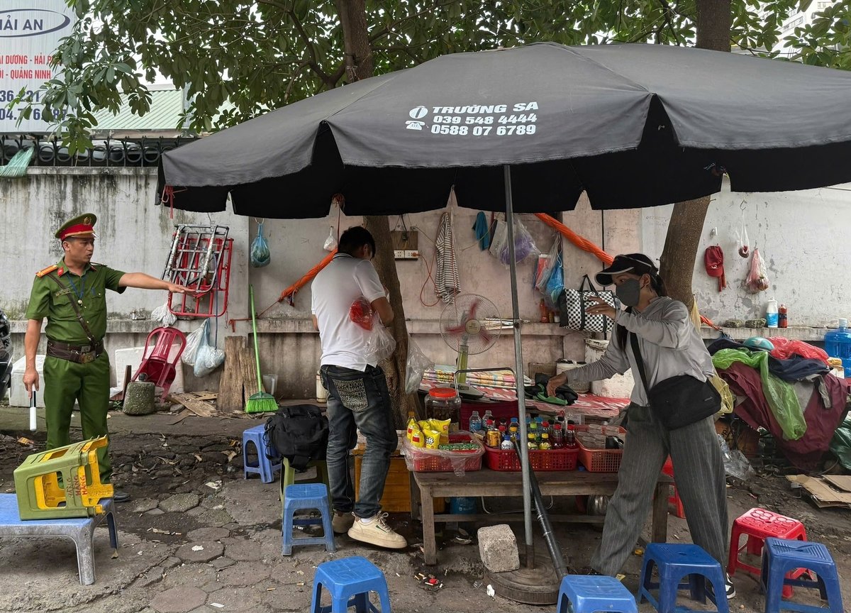 Lực lượng Cảnh sát trật tự - Công an phường Từ Liêm nhắc nhờ trường hợp lấn chiếm vỉa hè. Ảnh: Cao Sơn.
