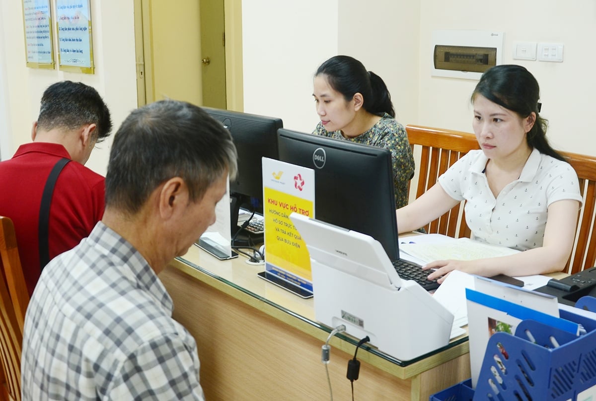 Cán bộ Trung tâm phục vụ hành chính công TP Hà Nội - chi nhánh số 3 hướng dẫn chi tiết người dân về thủ tục. Ảnh: Xuân Hà.