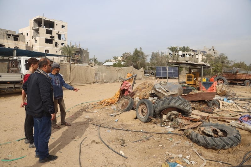 FAO staff look on as they assess damages to agricultural equipment, Khan Younis, Gaza Strip. Photo: FAO/Yousef Alrozzi.