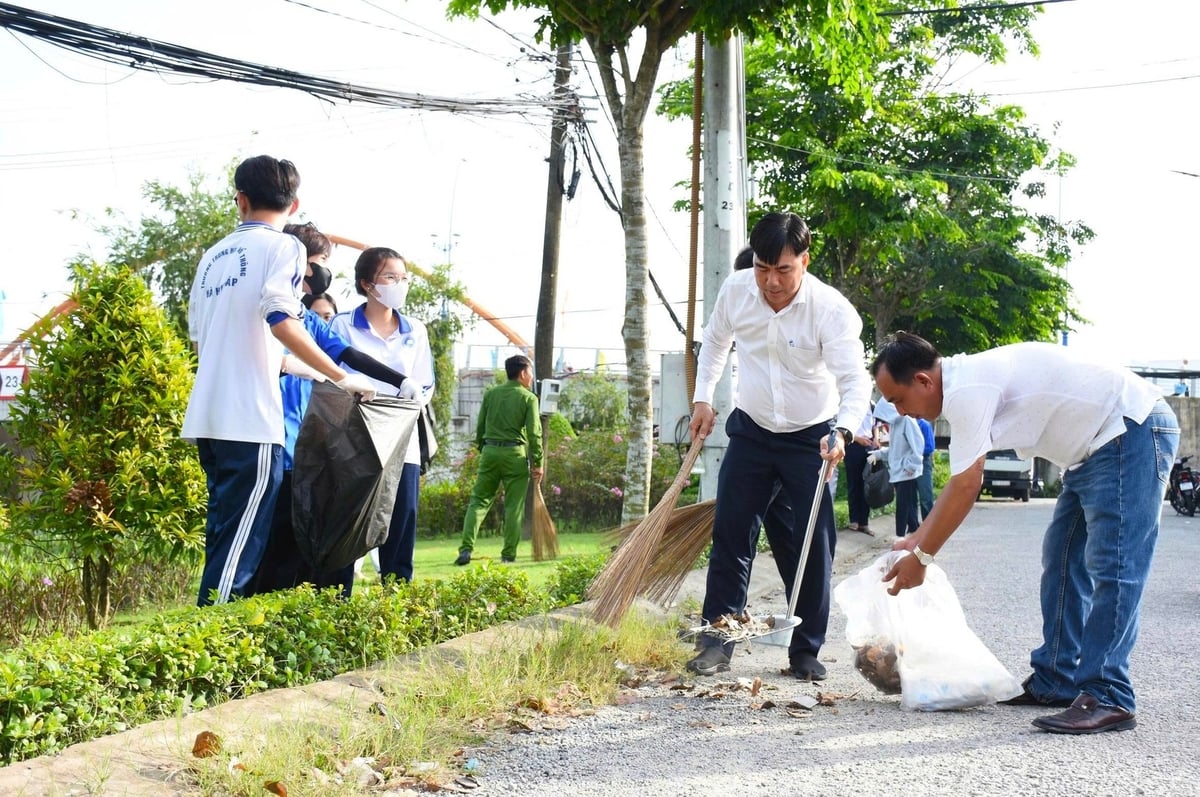 Lãnh đạo xã Cờ Đỏ cùng các lực lượng đoàn thể ra quân dọn dẹp, vệ sinh môi trường. Ảnh: Kim Anh.