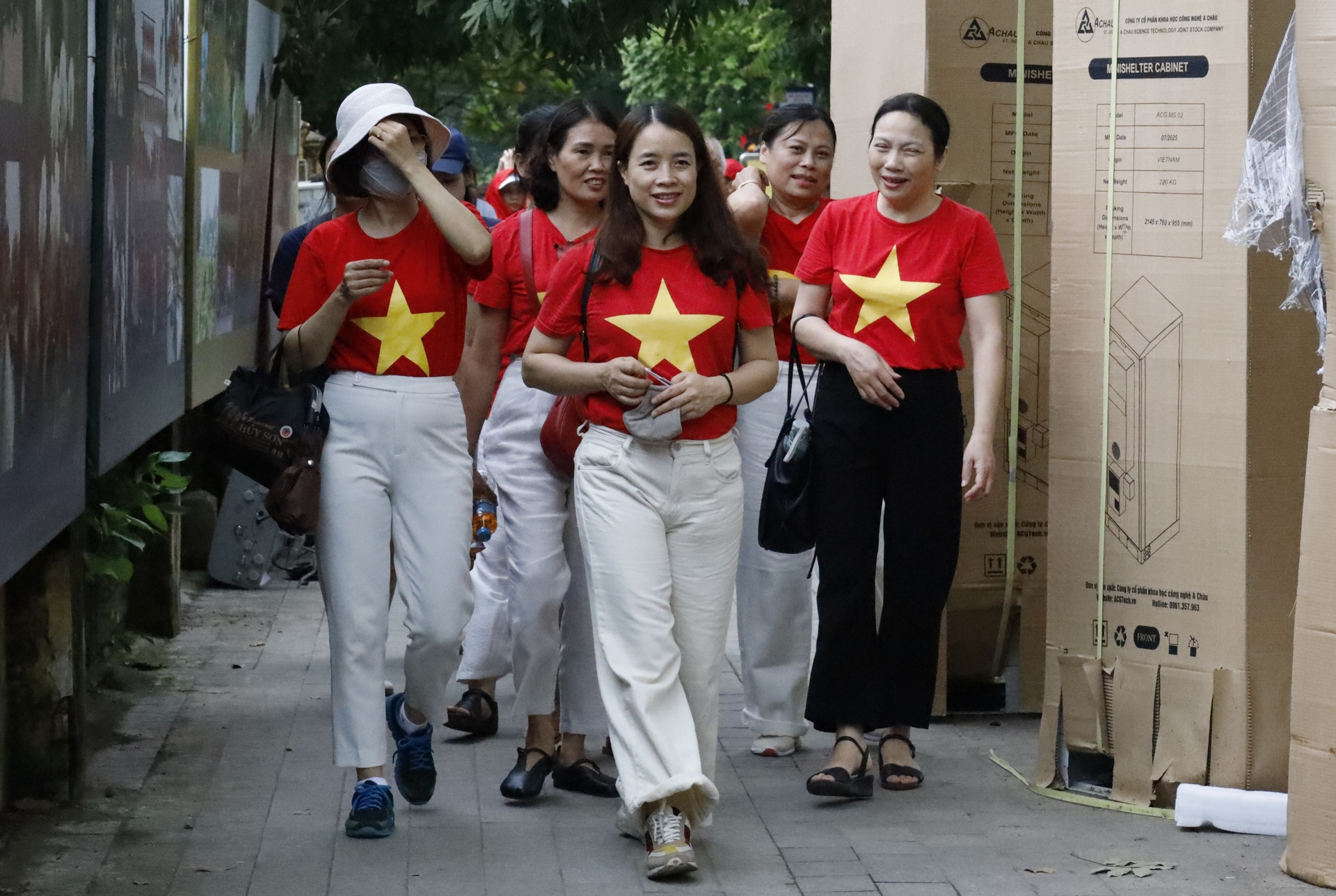 Nhiều tốp chị em với đồng phục áo đỏ sao vàng tươi vui như trong ngày hội. Ảnh: Hoàng Hiền.