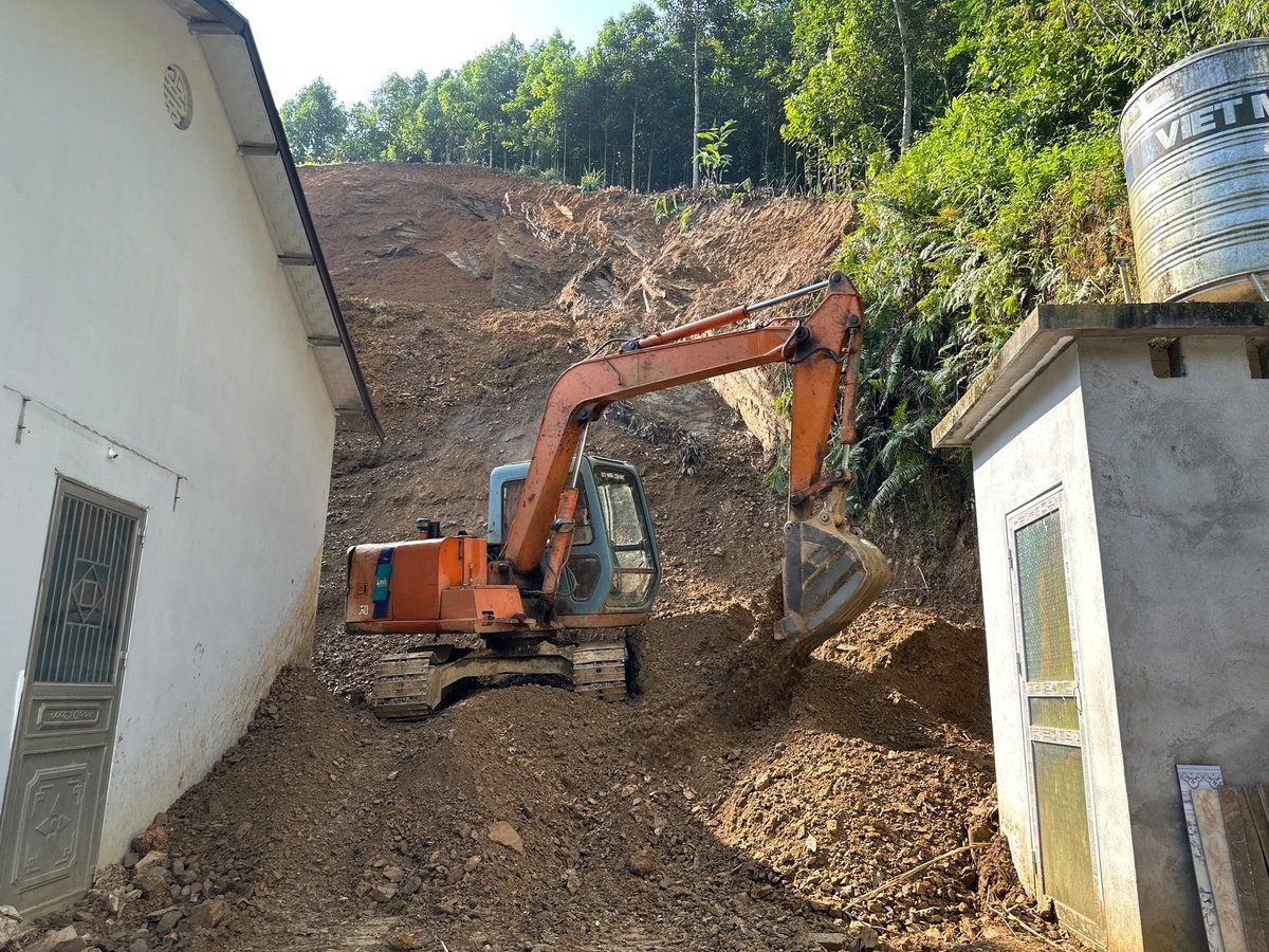 Máy xúc đất đá khỏi nhà ông Liều. Ảnh: Quang Linh. Máy xúc đất đá khỏi nhà ông Liều. Ảnh: Quang Linh.