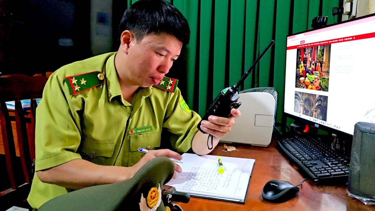 Anh Cao Văn Hùng, Phó Trạm trưởng Trạm kiểm lâm Đất Đỏ (xã Đắc Lua) tranh thủ viết thư, nhật ký cho gia đình trong đêm xuân nhưng vẫn không rời chiếc bộ đàm nhận thông tin. Ảnh: Nguyễn Thủy.