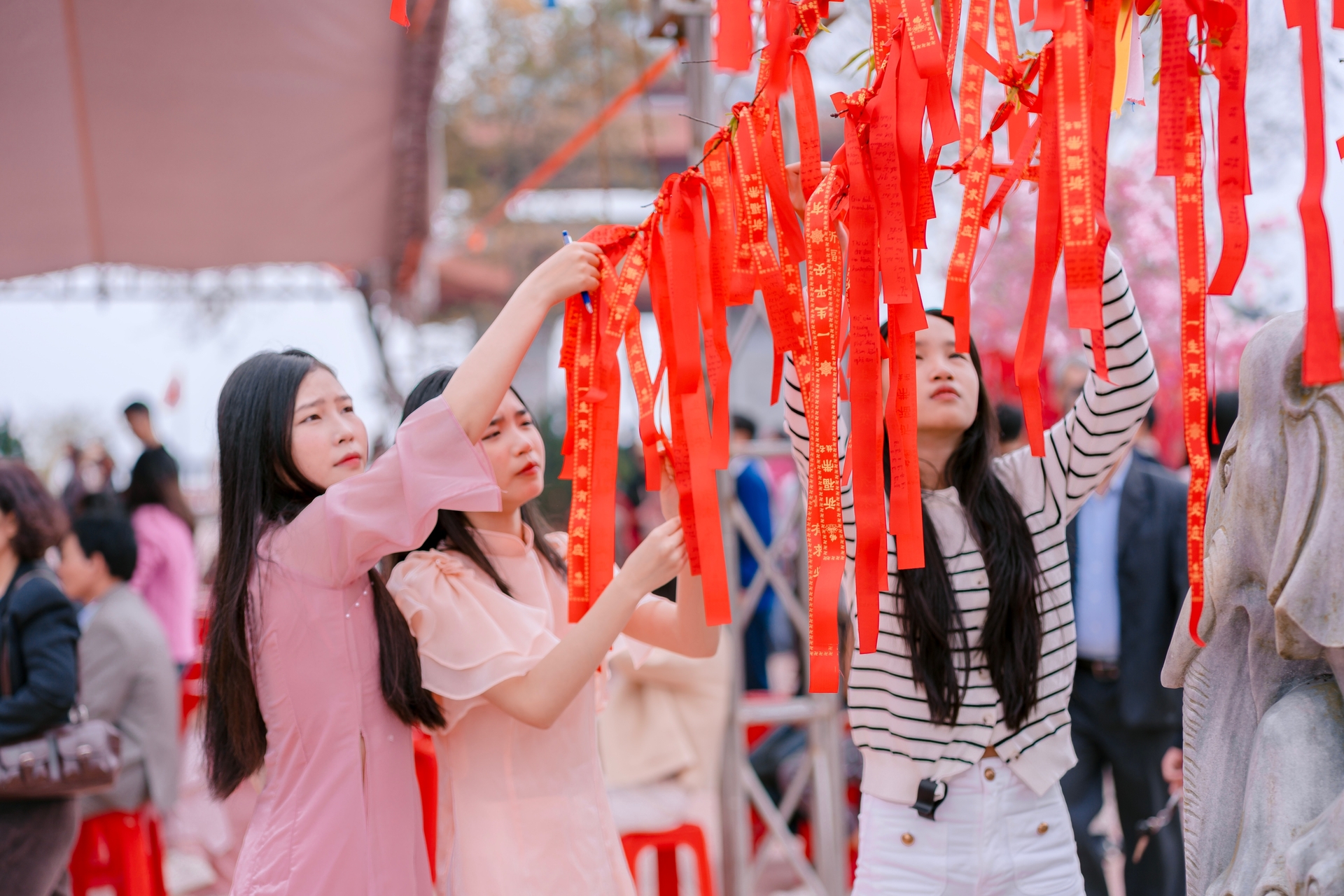 Du khách thành tâm treo dải điều ước đầu Xuân tại chùa Đại Tuệ (xã Đại Huệ, Nghệ An), gửi gắm mong ước bình an, may mắn trong năm mới Bính Ngọ 2026. Ảnh: Hữu Tình.