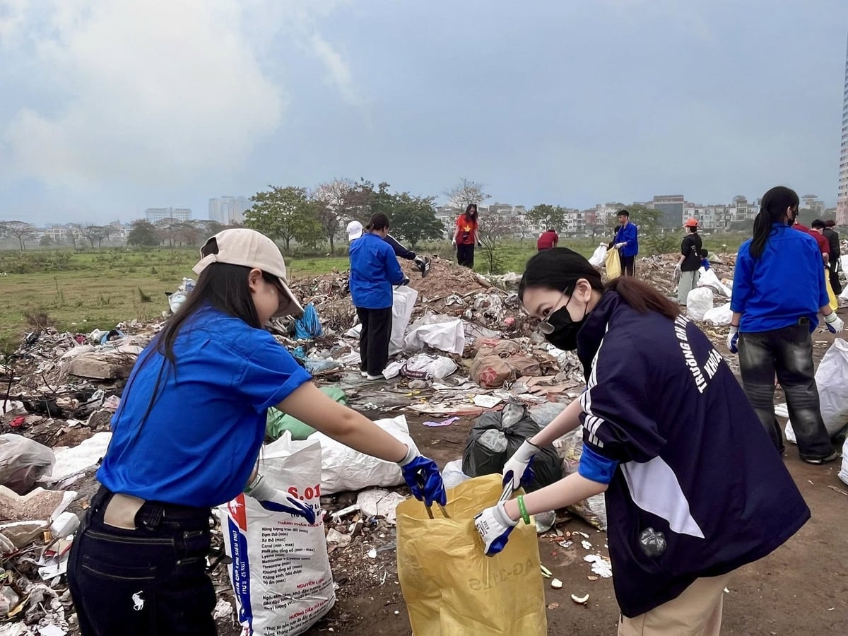 Các sinh viên không ngại nắng mưa, không ngại bẩn, tích cực thu gom rác thải, giữ gìn môi trường thủ đô, Ảnh: Giang Long.