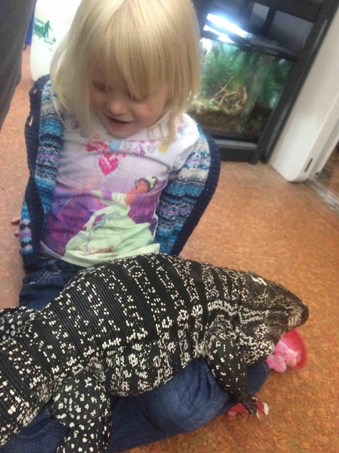 A little girl by her tegu lizard pet. Photo: Reddit.