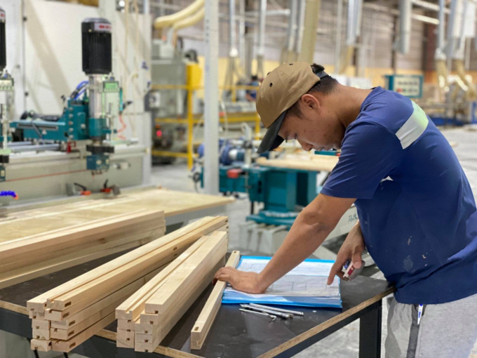 Producing wood furniture for export at factory of Tekcom company in Binh Duong province.