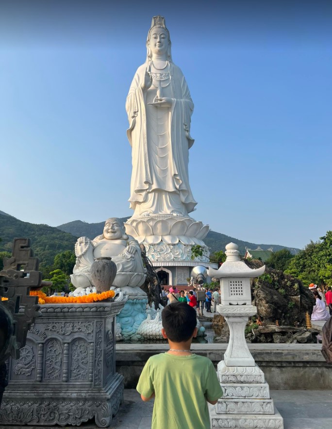 Trên mão tượng Quan Âm có tượng Phật Tổ cao 2m. Tượng Phật Quan Âm tựa lưng vào núi mặt hướng ra biển, một tay bắt ấn tam muội, tay kia cầm bình nước cam lồ. Ảnh: Linh Boo