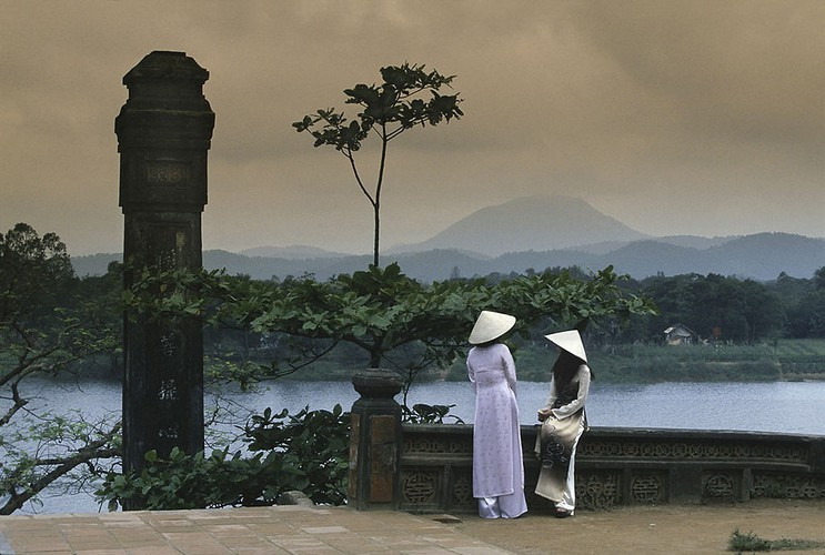 Hai thiếu nữ ngồi ở sân chùa Thiên Mụ, hậu cảnh là sông Hương, thập niên 1970