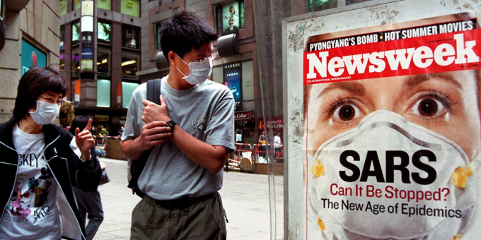 A_man_wears_a_surgical_mask_in_a_Hong_Kong_street_on_May_2_2003_AP_