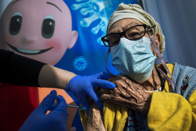 Jan._5_2021._file_photo_a_woman_receives_a_coronavirus_vaccine_from_medical_staff_at_a_COVID_19_vaccination_center_in_Tel_Aviv_Israel_AP_