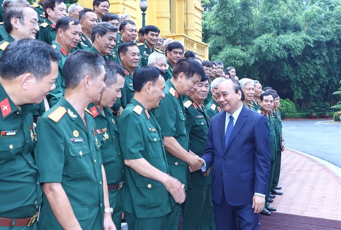 Chủ tịch nước Nguyễn Xuân Phúc cùng các đại biểu. Ảnh: VPCTN