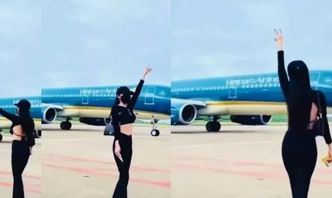 Nữ du khách nhảy nhót giữa sân bay Phú Quốc bất chấp máy bay bên cạnh đang lăn vào vị trí đỗ. Ảnh: VNE