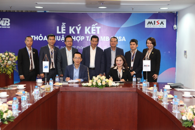Bà Đinh Thị Thúy - Tổng Giám đốc Công ty Cổ phần MISA ký kết thỏa thuận hợp tác cùng ông Vũ Thành Trung - Giám đốc Khối Ngân hàng số MB Bank dưới sự chứng kiến của ông Lưu Trung Thái - Phó Chủ tịch HĐQT, Tổng Giám đốc MB Bank (ở giữa) và đại diện hai bên