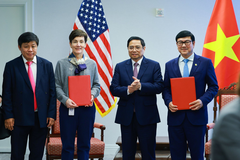 IFC's Senior Vice President Stephanie von Friedeburg (2nd, L) and HDBank Deputy CEO Tran Hoai Nam (1st, R) exchange their signed MoU in Washington May 11, 2022, while Vietnamese PM Pham Minh Chinh applauses. Photo courtesy of HDBank. 