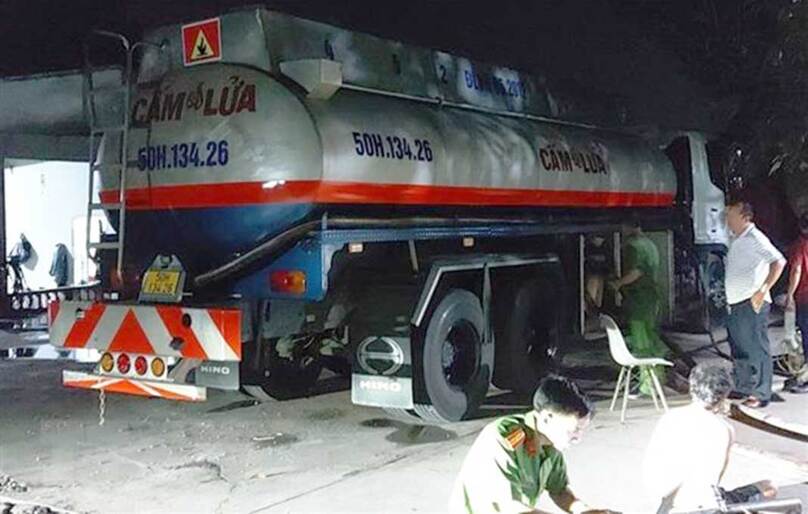 Police seize a tanker truck while it pumps chemicals into a storage sump of a gas station in Ba Ria-Vung Tau province, southern Vietnam. Photo courtesy of Vietnam News Agency.