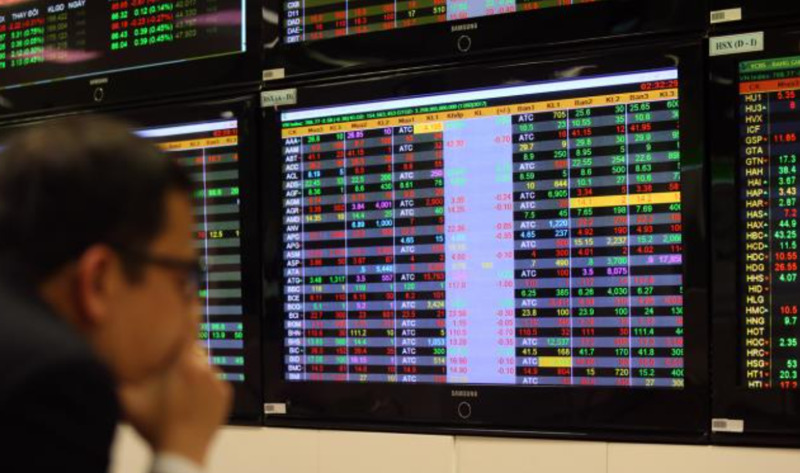 Investors track transactions at Vietcombank Securities trading board. Photo courtesy of Vietnam News Agency.