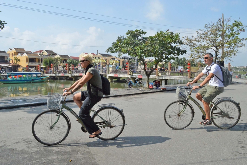 Foreign tourists cycle in the ancient town of Hoi An, central Vietnam. Photo courtesy of Hoianworldheritage.org.vn