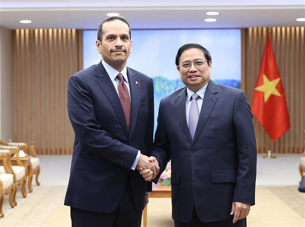 Vietnamese PM Pham Minh Chinh (R) meets with Qatari Deputy PM and Foreign Minister Mohammed bin Abdulrahman Al-Thani in Hanoi on August 15, 2022. Photo courtesy of Vietnam News Agency.