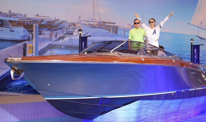 Customers take pictures with a yacht model at Novaland Gallery. Photo courtesy of Novaland.