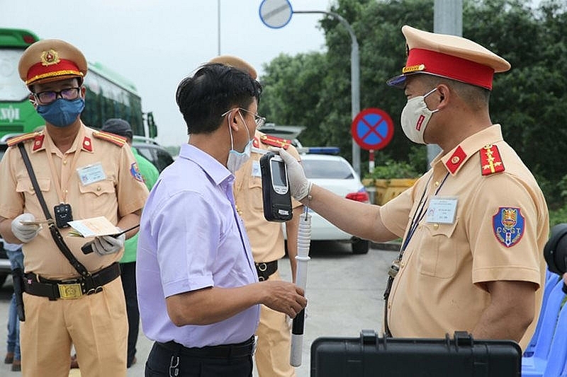 A traffic police officer conducts alcohol content test. Photo courtesy of New Day newspaper.