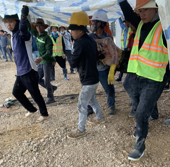 Workers move a victim from the accident scene. Photo courtesy of Youth newspaper.