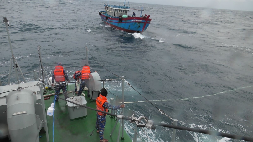 The Border Guard ship rescues a fishing vessel with engine failure and takes it to a storm shelter. Photo courtesy of Vietnam News Agency.