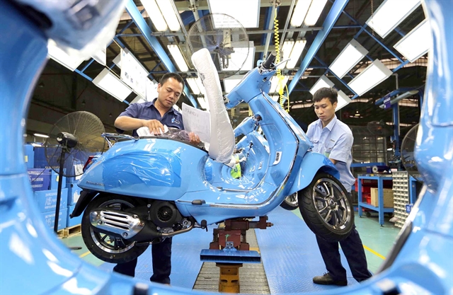 Workers at a Vespa scooter workshop of Piaggio Vietnam Co., Ltd. in Vinh Phuc province, northern Vietnam. Photo courtesy of Vietnam News Agency.