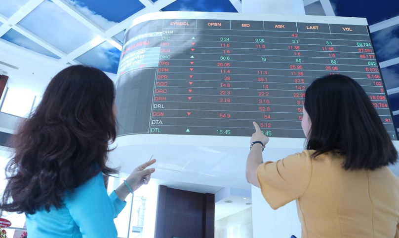 Vietnamese investors discuss stock prices. Photo by The Investor/Trong Hieu.