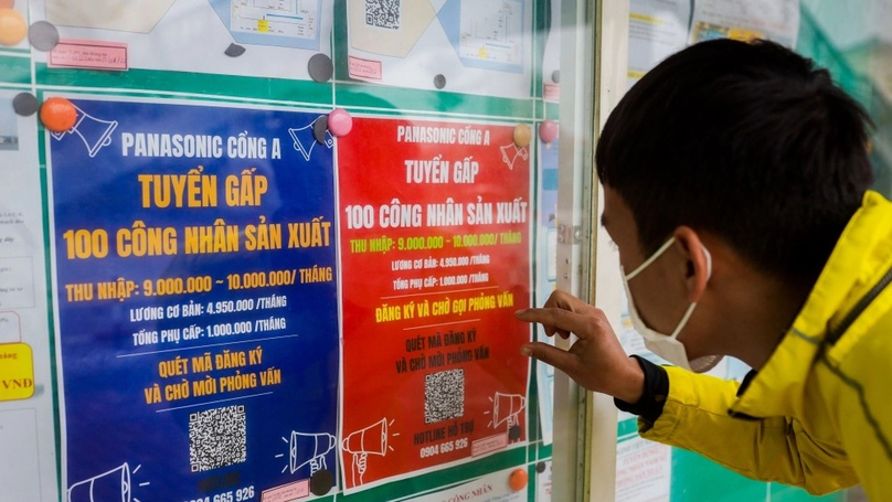 A man looks at a recruitment announcement in Hanoi. Photo by The Investor/Trong Hieu.