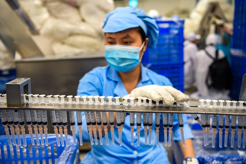 A Vietnamese worker at a medical syringe production line. Photo by The Investor/Trong Hieu.
