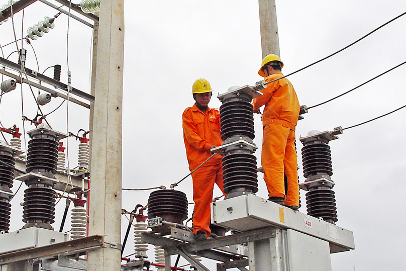 EVN technicians work on a transmission line. Photo courtesy of the group.