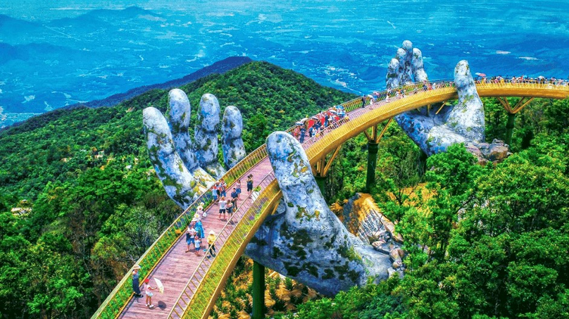 Tourists on the Golden Bridge at Ba Na Hills in Danang city, central Vietnam. Photo courtesy of Sun Group.