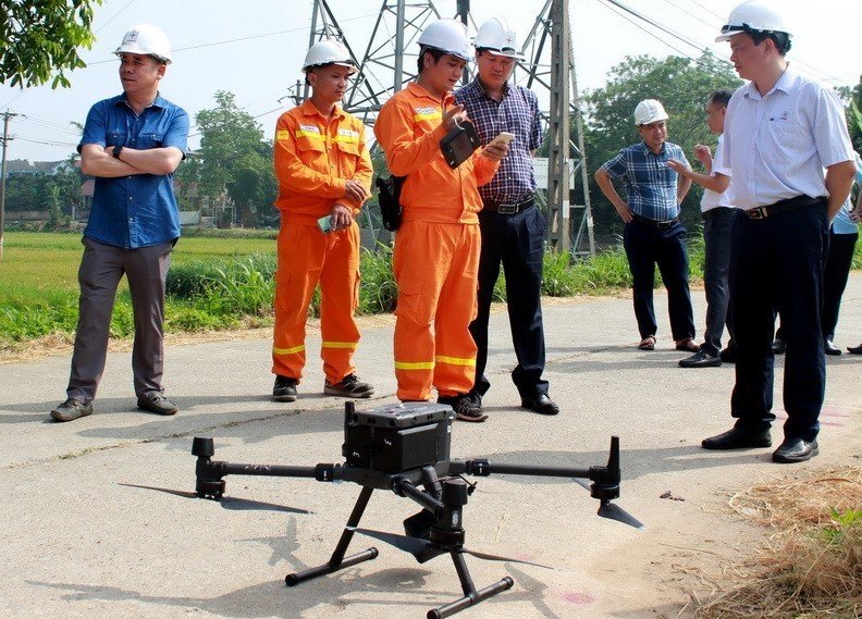 A team of EVN technicians and engineers use a drone to check a transmission line. Photo courtesy of EVN.