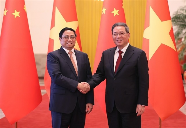 Prime Minister Pham Minh Chinh meets Chinese Premier Li Qiang during his ongoing official visit to China. Photo courtesy of VNA.