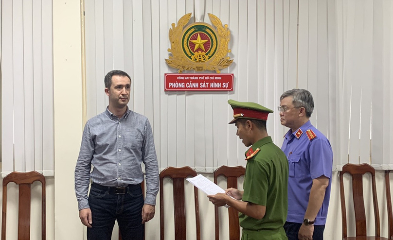 Russian national Maksim Zubkov (left) at the HCMC police's criminal police department. Photo courtesy of the police.