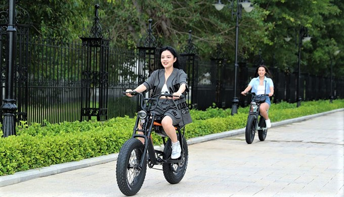 Two young women test-ride VinFast e-bikes in Nha Trang town, central Vietnam, July 22, 2023. Photo courtesy of Vingroup.