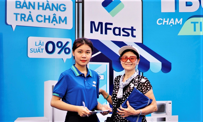 An MFast employee (left) with a customer. Photo courtesy of the firm.