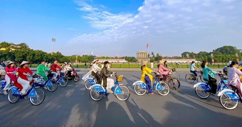 Hanoi citizens cycle past President Ho Chi Minh Mausoleum. Photo courtesy of the Voice of Vietnam. 