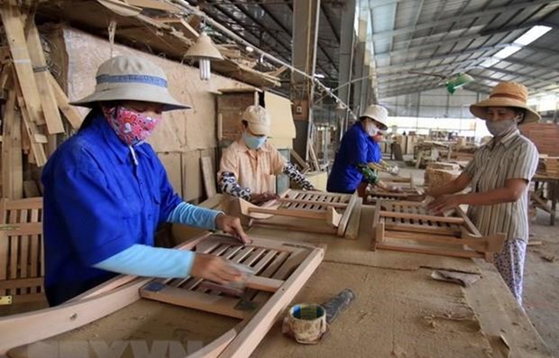 Processing wood for export. Photo courtesy of Vietnam News Agency.
