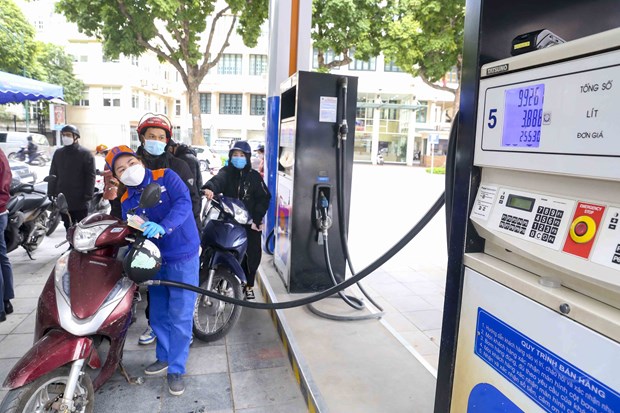A gasoline station employer refills a motobike. Photo courtesy of Vietnam News Agency.