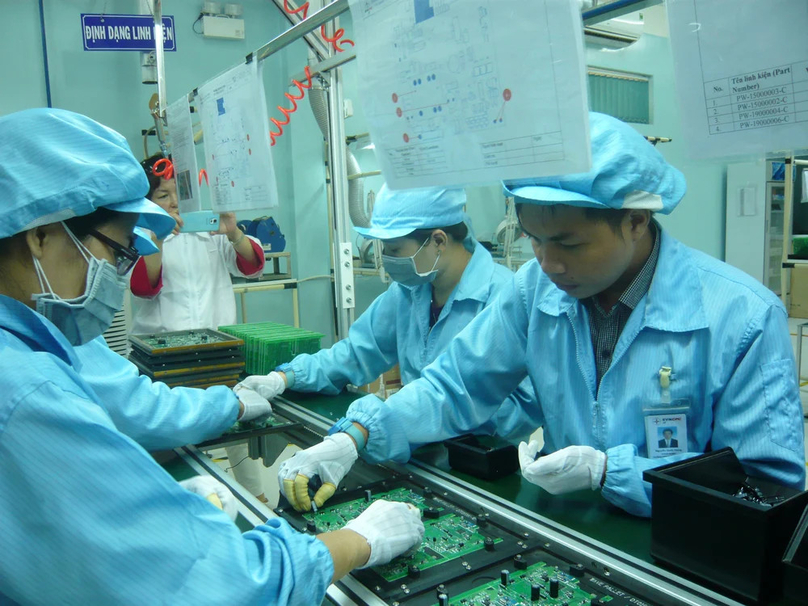 Workers at an electronic component production line. Photo by The Investor/Gia Anh.