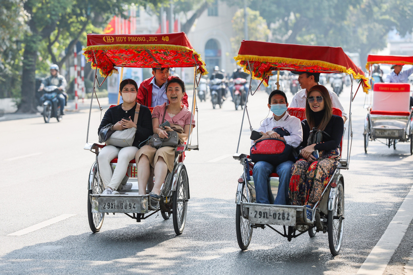Foreign visitors enjoy a cyclo ride in Hanoi. Photo courtesy of Dai Doan Ket (Great Unity) newspaper.