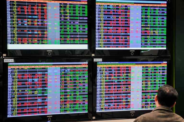 An investor watches stock prices at a securities companies in Hanoi. Photo by The Investor/Trong Hieu. 