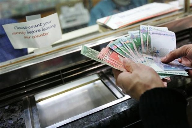 The Malaysian ringgit is counted at a currency exchange office in Kuala Lumpur. Photo courtesy of AFP.
