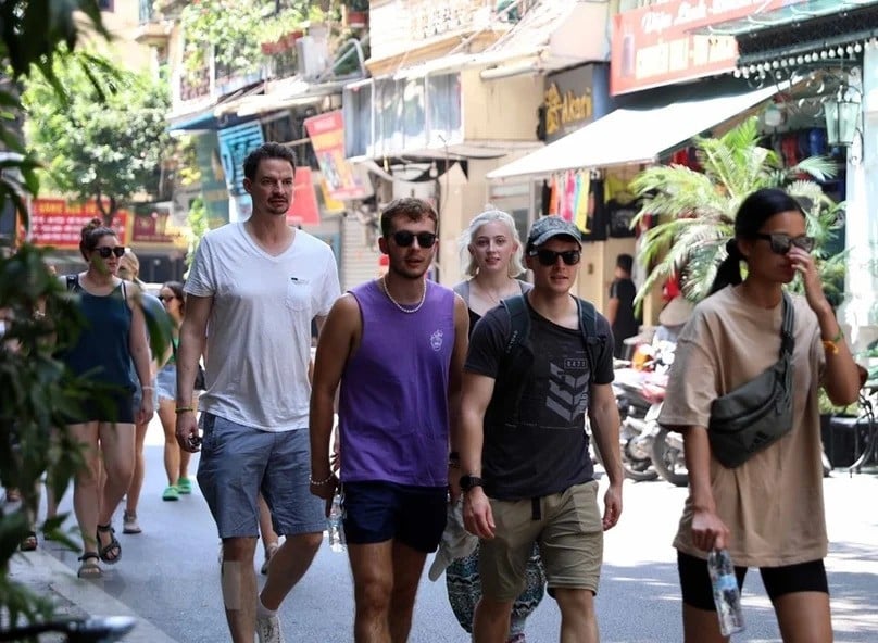  Foreign tourists walk on a street in Hanoi. Photo courtesy of Vietnam News Agency.
