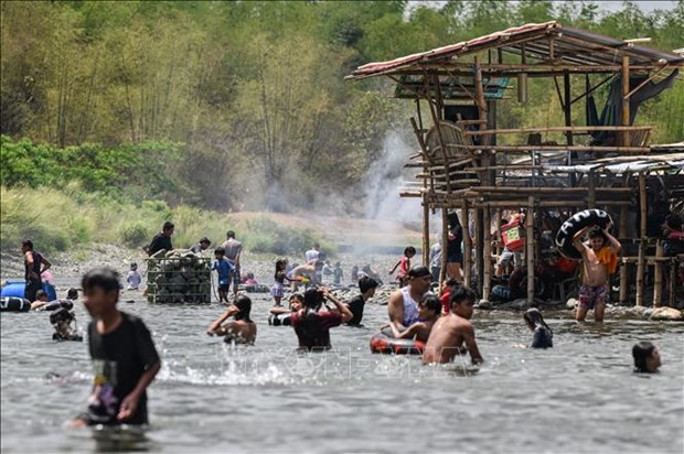 Philippiine people take a bath in a river amid hot weather. Photo courtesy of AFP/Vietnam News Agency.