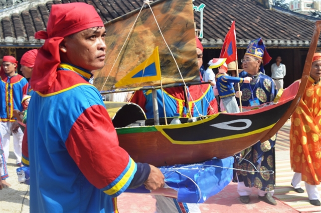 Local people re-enact a ceremony to see off the men enlisted by the Nguyen Lords in the 17th century for a flotilla to erect boundary sovereignty markers on the Hoang Sa (Paracel) and Truong Sa (Spratly) archipelagos, and patrol and collect marine resources from the seas. Photo courtesy of Vietnam News.