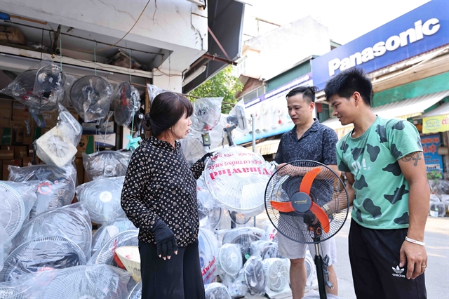 Fans are sold well during the early summer heat wave. Photo courtesy of Vietnam News Agency.